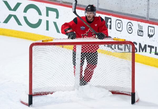 Canada's Sidney Crosby moves a net following practice for 4 Nations Face-Off hockey in Montreal on Monday, Feb. 10, 2025. Canada will face Sweden on Feb. 12. (Christinne Muschi/The Canadian Press via AP)