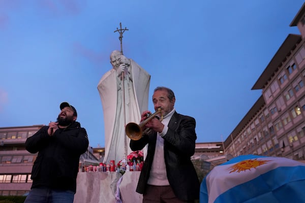 Trumpeter Felice Carella and singer Davide Capuano play the song Ave Maria for Pope Francis in front of the Agostino Gemelli Polyclinic, where the Pontiff has been hospitalized since Feb. 14, in Rome, Wednesday, Feb. 26, 2025. (AP Photo/Kirsty Wigglesworth)