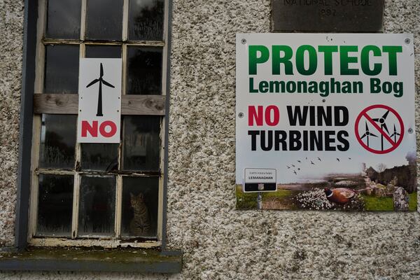 Protest banners against wind turbines displayed on a building in Lemanaghan, Ireland, Wednesday, Oct. 16, 2024. (AP Photo/Bram Janssen)