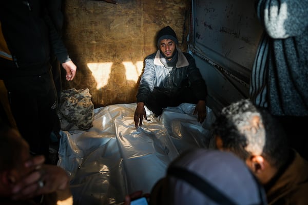 Mourners attend the funeral of three members of Imad Al-deen family who were killed in the Israeli bombardment in Bureij, central Gaza Strip, at Al-Aqsa Martyrs Hospital in Deir al-Balah, Monday, Jan. 6, 2025. (AP Photo/Abdel Kareem Hana)