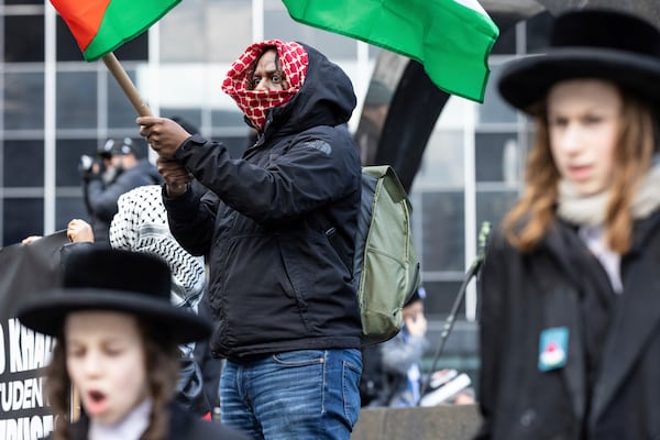 A person waves a Palestinian flag in Foley Square, outside the Manhattan federal court, prior to the deportation case of Mahmoud Khalil, Wednesday, March 12, 2025, in New York. (AP Photo/Stefan Jeremiah)