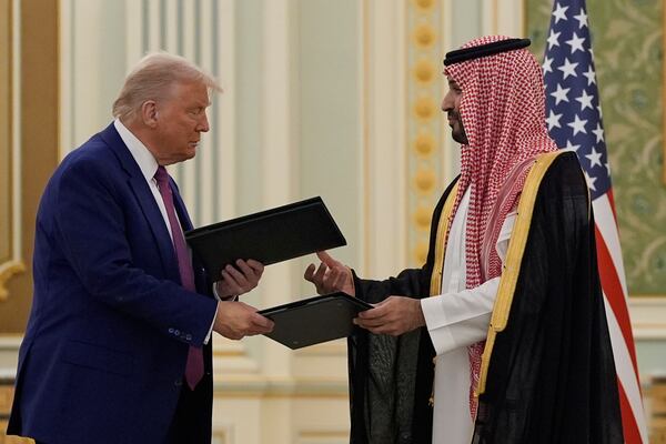 President Donald Trump and Saudi Crown Prince Mohammed bin Salman exchange documents during a signing ceremony at the Royal Palace, Tuesday, May 13, 2025. (AP Photo/Alex Brandon)
