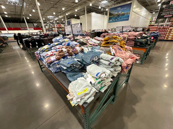 FILE - Children's clothing sits stacked on a table for shoppers in a Costco warehouse Thursday, Jan. 23, 2025, in Sheridan, Colo. (AP Photo/David Zalubowski, File)