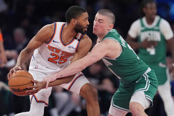 Boston Celtics' Payton Pritchard, right, defends New York Knicks' Mikal Bridges during the second half of Game 6 in the Eastern Conference semifinals of the NBA basketball playoffs Friday, May 16, 2025, in New York. (AP Photo/Frank Franklin II)