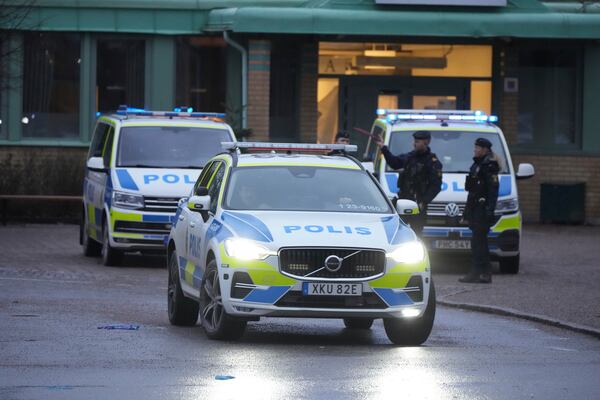 Police officers stand guard near the scene of a shooting at an adult education center on the outskirts of Orebro, Sweden, Wednesday, Feb. 5, 2025. (AP Photo/Sergei Grits)