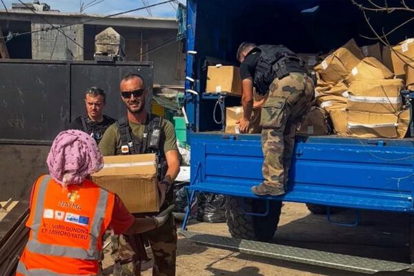 This photo provided by the French Interior Ministry shows French gendarmes unloading supplies in Koungou, in the Indian Ocean French territory of Mayotte, Wednesday Dec.18, 2024. (Ministere de l'Interieur/Gendarmerie Nationale via AP)