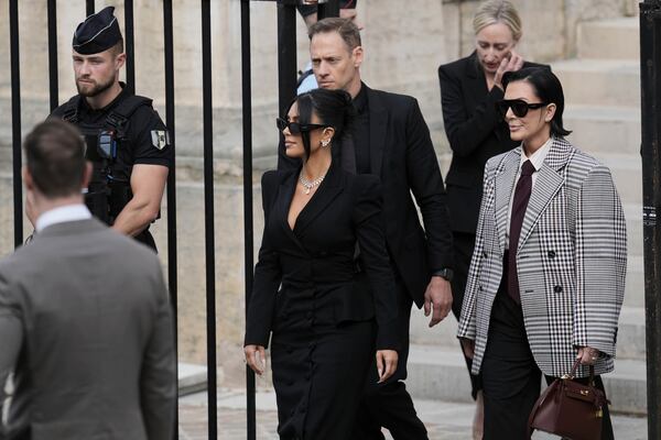 Kim Kardashian, center, accompanied by her mother Kris Jenner, right, leaves the justice palace after testifying, regarding a robbery of millions of dollars in jewels from her Paris hotel room in 2016, in Paris, Tuesday, May 13, 2025. (AP Photo/Aurelien Morissard)