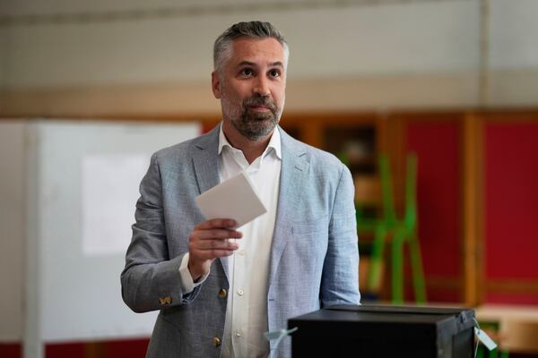 Socialist Party secretary general Pedro Nuno Santos holds his ballot when voting in Portugal's general election at a polling station in Lisbon, Sunday, May 18, 2025. (AP Photo/Armando Franca)