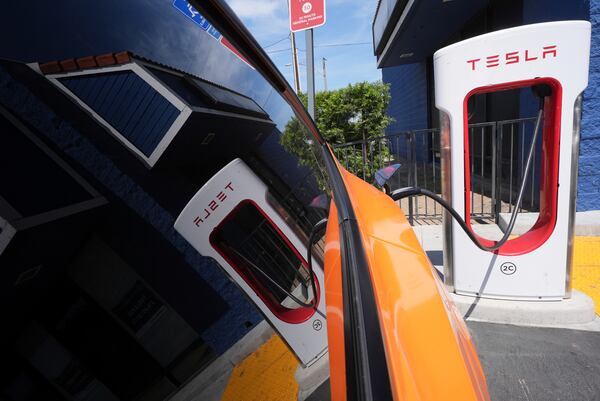 An electric vehicle is seen charging at a charging station Thursday, May 22, 2025, in Long Beach, Calif. (AP Photo/Damian Dovarganes)