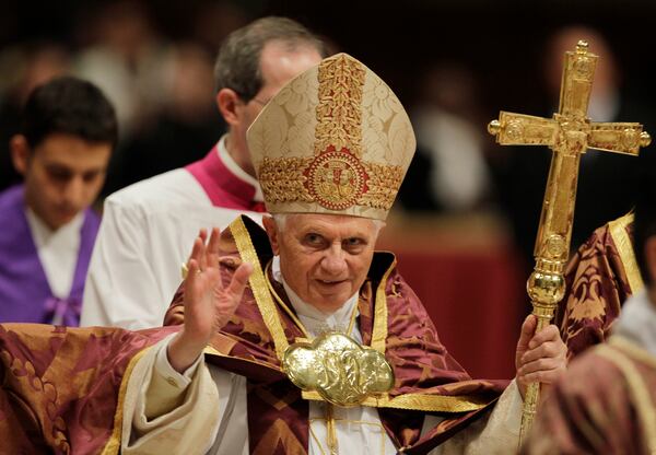 FILE - Pope Benedict XVI blesses the faithful as he arrives at St. Peter's Basilica in the Vatican, Dec. 16, 2010. (AP Photo/Alessandra Tarantino, File)