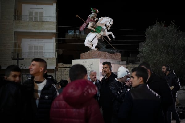 People gather after attending a Christmas mass at the church of St. George, in Maaloula, some 60 km northern Damascus, Syria, Tuesday, Dec. 24, 2024. (AP Photo/Leo Correa)