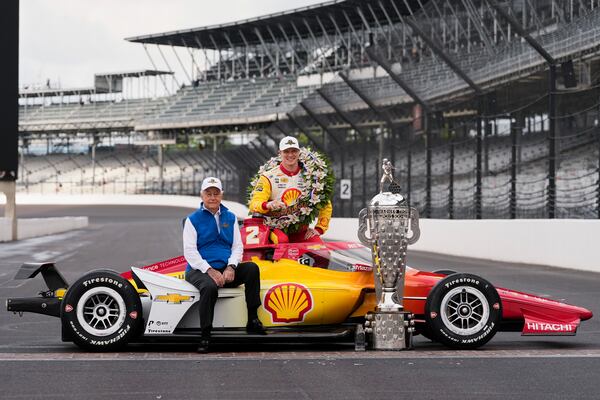 FILE - Roger Penske and Josef Newgarden pose with the Borg-Warner Trophy during the traditional winner's photo session at Indianapolis Motor Speedway, Monday, May 27, 2024, in Indianapolis, the day after he won the 108th running of the Indianapolis 500 auto race. (AP Photo/Darron Cummings, File)