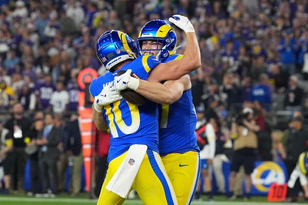 Los Angeles Rams tight end Davis Allen (87) celebrates his 13-yard touchdown reception with Cooper Kupp (10) during the first half of an NFL wild card playoff football game against the Minnesota Vikings, Monday, Jan. 13, 2025, in Glendale, Ariz. (AP Photo/Ross D. Franklin)