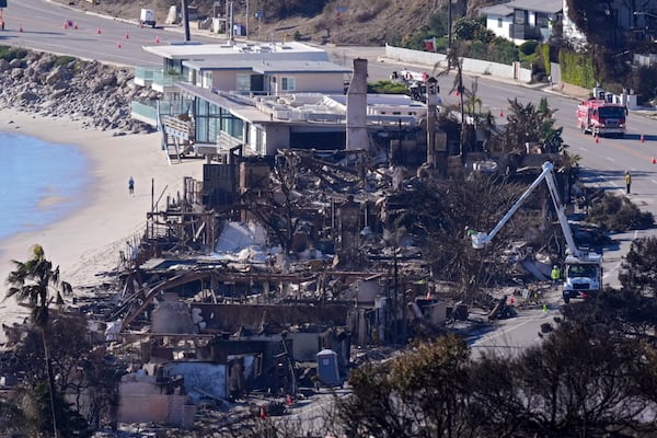 FILE - Homes along Pacific Coast Highway are seen burned and damaged while a few still stand after the Palisades Fire, Jan. 12, 2025, in Malibu, Calif. (AP Photo/Mark J. Terrill, File)