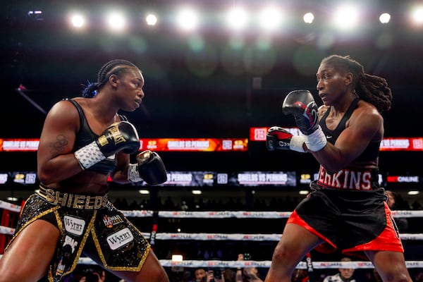 Claressa Shields, left, fights with Danielle Perkins during the undisputed heavyweight title match on Sunday, Feb. 2, 2025 at Dort Financial Center in Flint. (Jake May/The Flint Journal via AP)