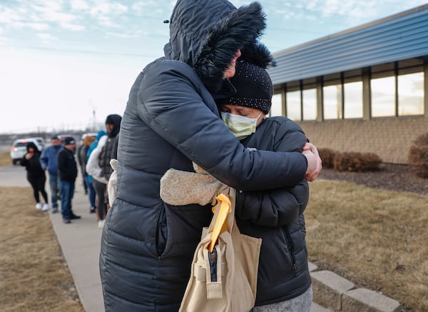 FILE - Jonna Higgins-Freese, left, of Iowa City, Iowa, hugs a woman waiting for her immigration check-in outside of the U.S. Immigration and Customs Enforcement office in Cedar Rapids, Iowa, Feb. 4, 2025. (Jim Slosiarek/The Gazette Via AP, File)