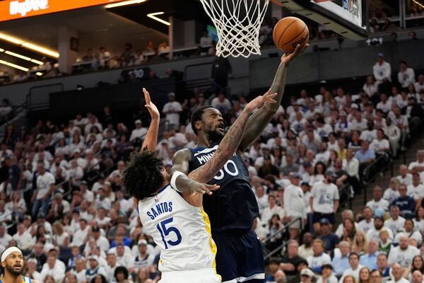 Minnesota Timberwolves forward Julius Randle (30) shoots over Golden State Warriors forward Gui Santos (15) during the second half of Game 5 of an NBA basketball second-round playoff series, Wednesday, May 14, 2025, in Minneapolis. (AP Photo/Abbie Parr)