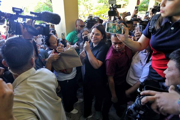 Philippine Vice President Sara Duterte, center, arrives to cast her vote at a polling center in Davao City, southern Philippines, Monday, May 12, 2025. (AP Photo/Manman Dejeto)