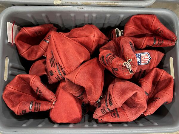 A bin of official balls for the NFL Super Bowl football game wait to be finished inside the Wilson Sporting Goods football factory, Monday, January 27, 2025, in Ada, Ohio. (AP Photo/Patrick Aftoora-Orsagos)