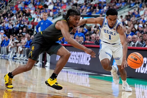 Baylor guard Jayden Nunn and Duke guard Caleb Foster chase a loose ball during the first half in the second round of the NCAA college basketball tournament, Sunday, March 23, 2025, in Raleigh, N.C. (AP Photo/Chris Carlson)