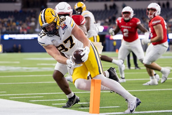 California tight end Jack Endries, left, is stopped short of the goal line by UNLV defensive back Jalen Catalon during the first half of the LA Bowl NCAA college football game Wednesday, Dec. 18, 2024, in Inglewood, Calif. (AP Photo/Ryan Sun)