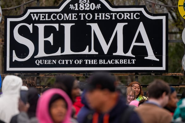 People march over the Edmund Pettus bridge during the 60th anniversary of the march to ensure that African Americans could exercise their constitutional right to vote, Sunday, March 9, 2025, in Selma, Ala. (AP Photo/Mike Stewart)