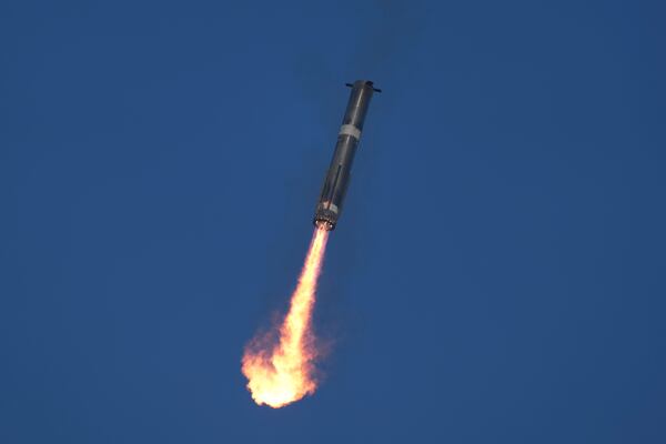 SpaceX's mega rocket Starship booster returns to the launch pad during a test flight from Starbase in Boca Chica, Texas, Thursday, Jan. 16, 2025. (AP Photo/Eric Gay)