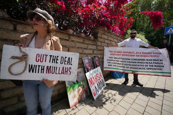 Iranian citizens protest against the current Iranian government outside the Omani Embassy in Rome during the closed-door meeting between U.S. and Iranian delegations to discuss Tehran's rapidly advancing nuclear program, Friday, May 23, 2025. (AP Photo/Andrew Medichini)