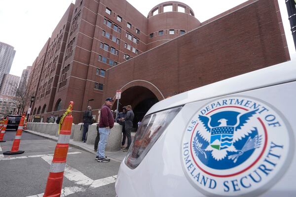FILE - A Homeland Security vehicle, right, is parked outside the Moakley Federal Courthouse, April 19, 2023, in Boston. . (AP Photo/Steven Senne, File)