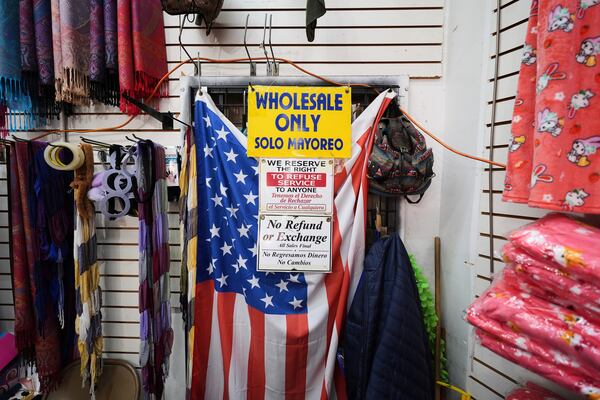 FILE - An American flag hangs in a store owned by Kyung Sook Im in the Toy District of Los Angeles, Wednesday, April 9, 2025, where the majority of the merchandise is imported from China. (AP Photo/Jae C. Hong, File)