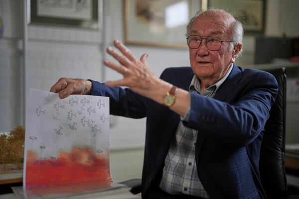 John Goldsmith, 94, shows his drawing during an interview at his home in London, Thursday, April 24, 2025. (AP Photo/Kin Cheung)