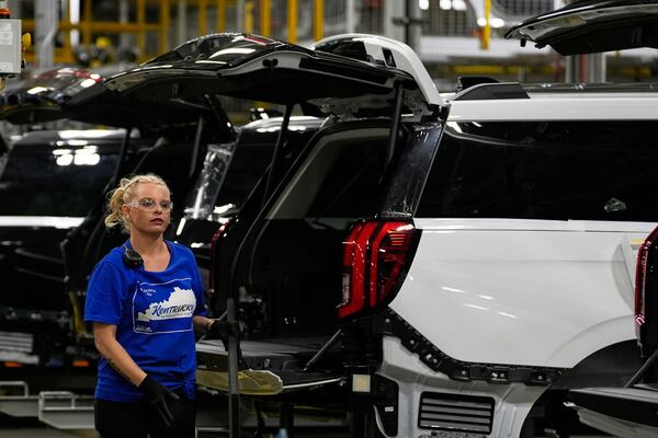A vehicle assembly technician works on 2025 Ford Expeditions during a media tour to launch the 2025 Ford Expedition at the Ford Motor Company Kentucky Truck Plant, Wednesday, April 30, 2025, in Louisville, Ky. (AP Photo/Carolyn Kaster)