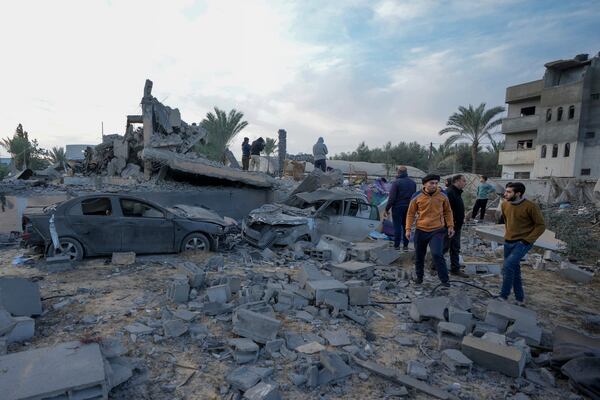 Palestinians inspect the site of an Israeli strike in Deir Al-Balah in the central Gaza Strip, Wednesday, Jan. 15, 2025. (AP Photo/Abdel Kareem Hana)