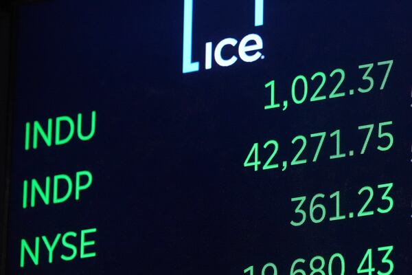 The Dow Jones industrial average, top, opens higher at the New York Stock Exchange, Monday, May 12, 2025. (AP Photo/Richard Drew)