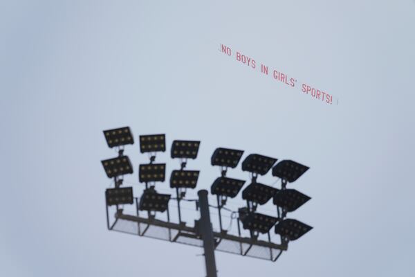 A banner reading "NO BOYS IN GIRLS' SPORTS!" is flown above Veteran's Memorial Stadium during the California high school track-and-field championships in Clovis, Calif., Friday, May 30, 2025. (AP Photo/Jae C. Hong)