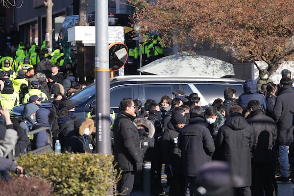 One of motorcade for impeached South Korean President Yoon Suk Yeol leaves for the Corruption Investigation Office for High-ranking Officials from the gate of the presidential residence in Seoul, South Korea, Wednesday, Jan. 15, 2025. (AP Photo/Lee Jin-man)