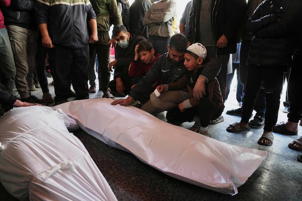 Palestinians mourn over the bodies of Al-Mashharawi family members, who were killed in an Israeli airstrike that hit their home, at Al-Ahli Hospital in Gaza City on Saturday, March 22, 2025. (AP Photo/Jehad Alshrafi)