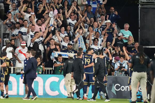 Vancouver Whitecaps fans cheer after a CONCACAF Champions Cup second-leg semifinal soccer match between Inter Miami and the Vancouver Whitecaps, Wednesday, April 30, 2025, in Fort Lauderdale, Fla. (AP Photo/Lynne Sladky)
