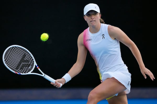 Iga Swiatek of Poland plays a forehand return to Eva Lys of Germany during their fourth round match at the Australian Open tennis championship in Melbourne, Australia, Monday, Jan. 20, 2025. (AP Photo/Vincent Thian)