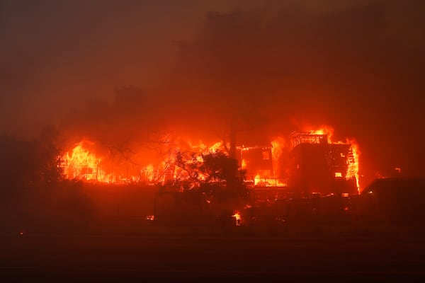 The Palisades Fire burns a property in the Pacific Palisades neighborhood of Los Angeles, Tuesday, Jan. 7, 2025. (AP Photo/Etienne Laurent)