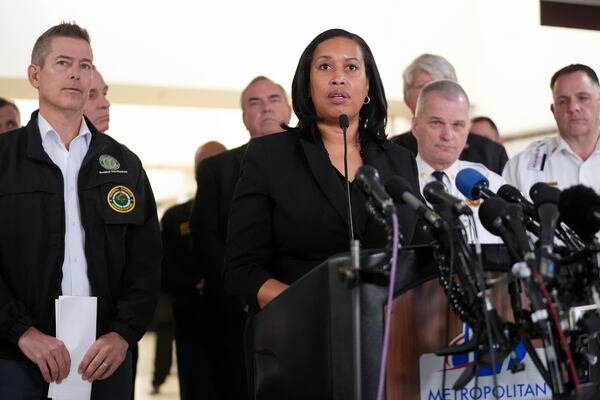 District of Columbia Mayor Muriel Bowser, with Transportation Secretary Sean Duffy, left, and others, speaks during a news conference at Ronald Reagan Washington National Airport, Thursday morning, Jan. 30, 2025, in Arlington, Va. (AP Photo/Mark Schiefelbein)