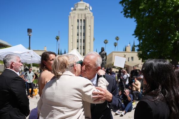 Attorney Mark Geragos, a lawyer for Erik and Lyle Menendez, center right, kisses a family member of the brothers after a hearing in their case at the courthouse Friday, May 9, 2025, in Los Angeles. (AP Photo/Jae C. Hong)