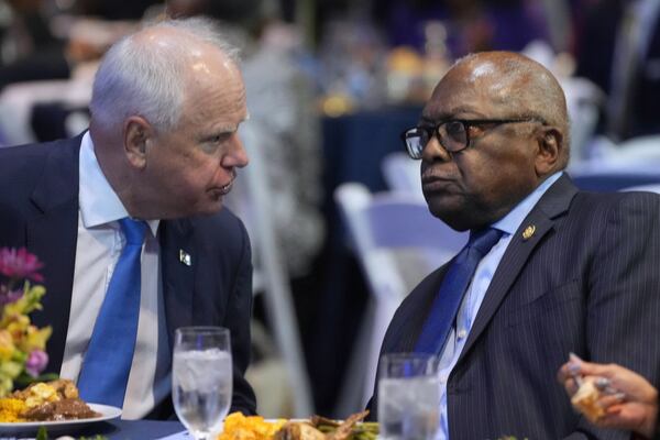 Minnesota Gov. Tim Walz speaks with Rep. Jim Clyburn, D-S.C., at the South Carolina Democratic Party's Blue Palmetto Dinner Friday, May 30, 2025, in Columbia, S.C. (AP Photo/Meg Kinnard)