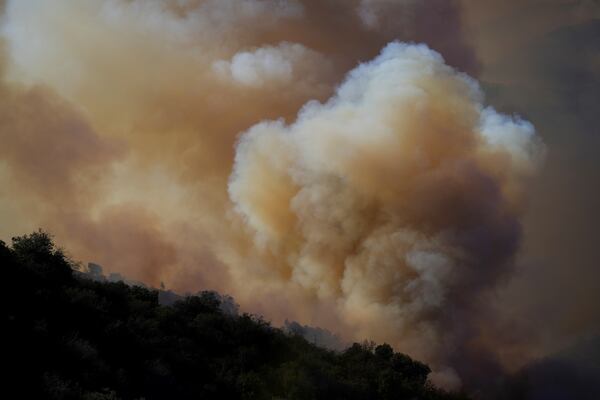 The Palisades Fire continues to burn in the outskirts of the Pacific Palisades neighborhood of Los Angeles, Friday, Jan. 10, 2025. (AP Photo/Eric Thayer)