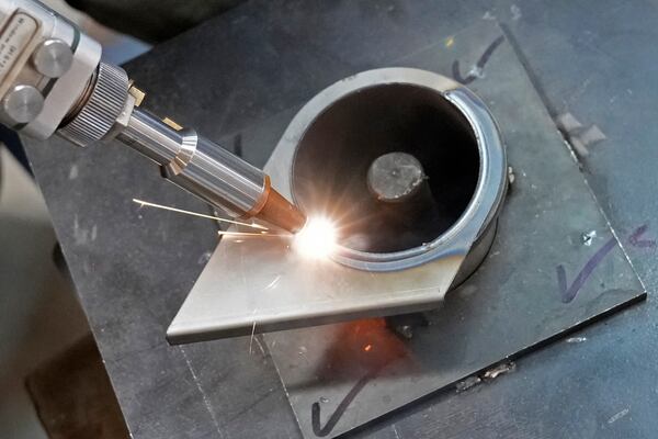 A worker welds a part made from steel sheets at a factory in a suburb of Bengaluru, India, Thursday, Feb. 27, 2025. (AP Photo/Aijaz Rahi)