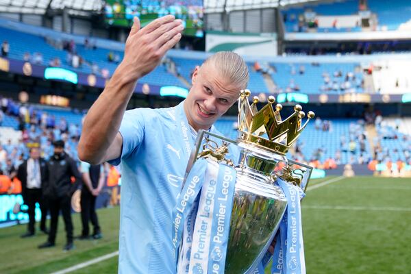 FILE -Manchester City's Erling Haaland celebrates with the Premier League trophy after the English Premier League soccer match between Manchester City and West Ham United at the Etihad Stadium in Manchester, England, May 19, 2024. (AP Photo/Dave Thompson, File)