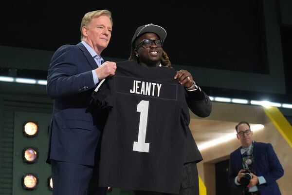 Boise State running back Ashton Jeanty, right, poses with NFL Commissioner Roger Goodell after being chosen by the Las Vegas Raiders with the sixth overall pick during the first round of the NFL football draft, Thursday, April 24, 2025, in Green Bay, Wis. (AP Photo/Jeff Roberson)