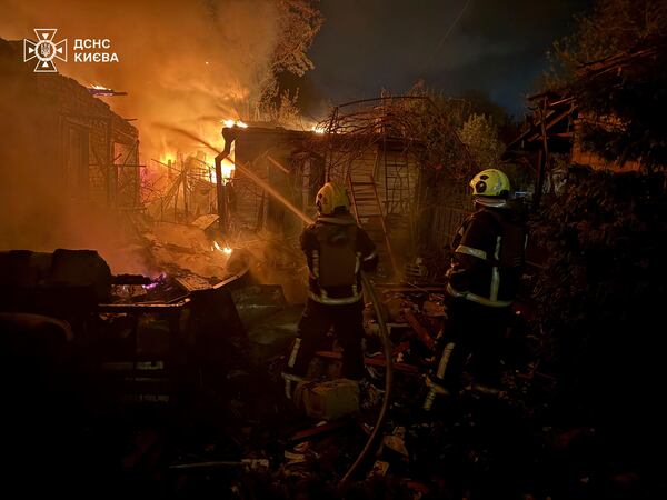 In this photo provided by the Ukrainian Emergency Service, emergency services personnel work to extinguish a fire following a Russian attack in Kyiv, Ukraine, Sunday, May 4, 2025. (Ukrainian Emergency Service via AP)