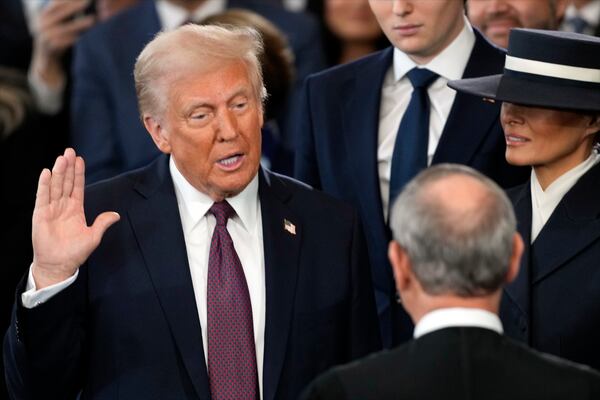 Donald Trump is sworn in as the 47th president of the United States by Chief Justice John Roberts as Melania Trump holds the Bible during the 60th Presidential Inauguration in the Rotunda of the U.S. Capitol in Washington, Monday, Jan. 20, 2025. (AP Photo/Julia Demaree Nikhinson, Pool)