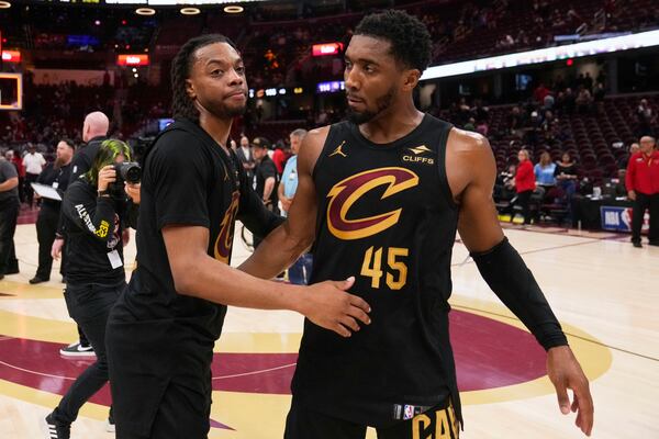 Cleveland Cavaliers guard Darius Garland, left, and guard Donovan Mitchell hug each other after the Indiana Pacers defeated the Cavaliers 114-105 in Game 5 of an Eastern Conference semifinal NBA basketball playoff Tuesday, May 13, 2025, in Cleveland. (AP Photo/Sue Ogrocki)
